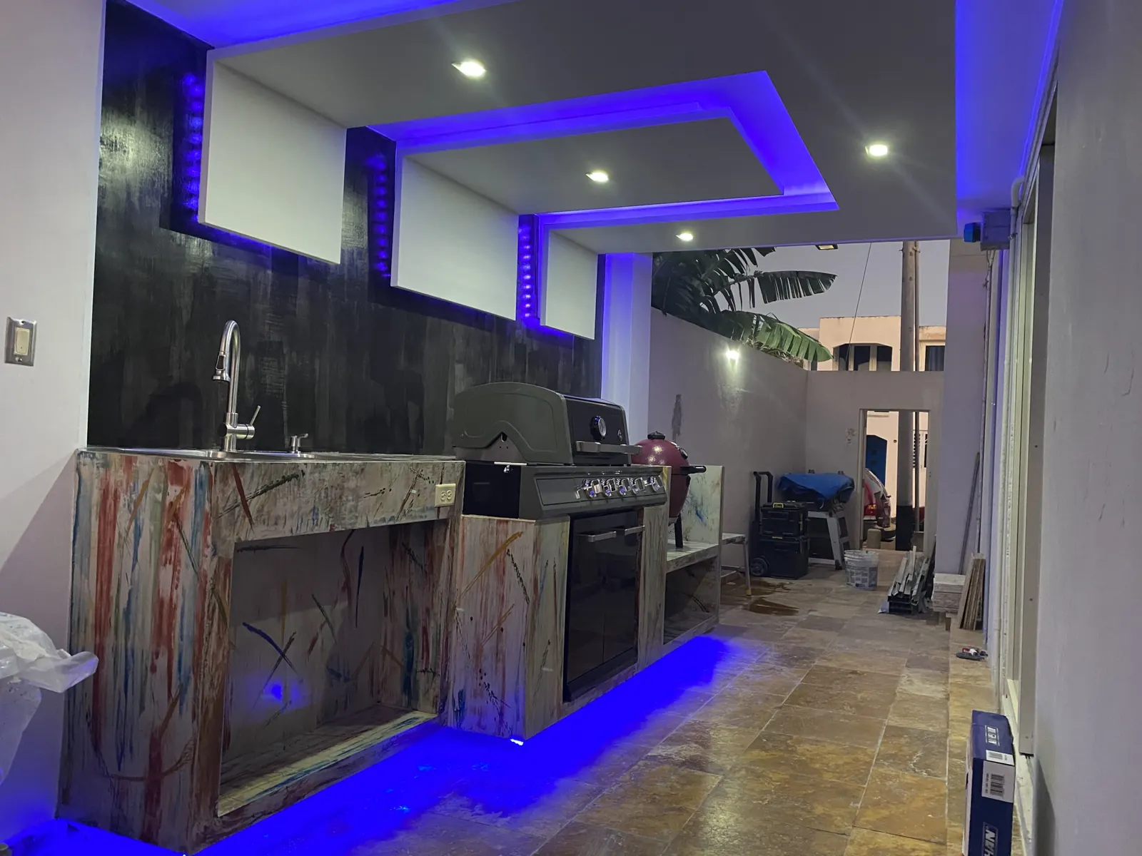 Outdoor kitchen with BBQ counters and LED lighting