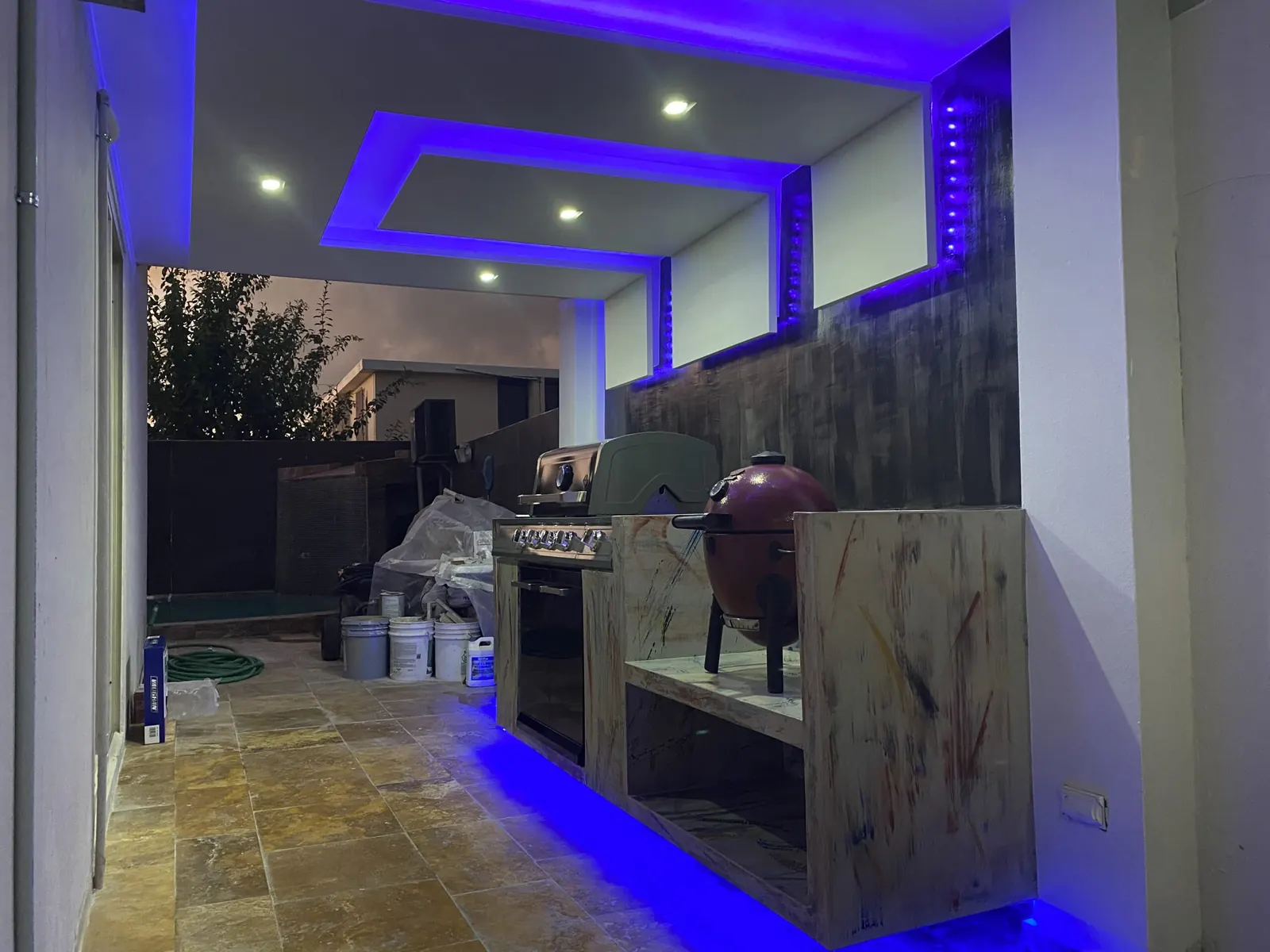Outdoor kitchen with stone counters and LED lighting