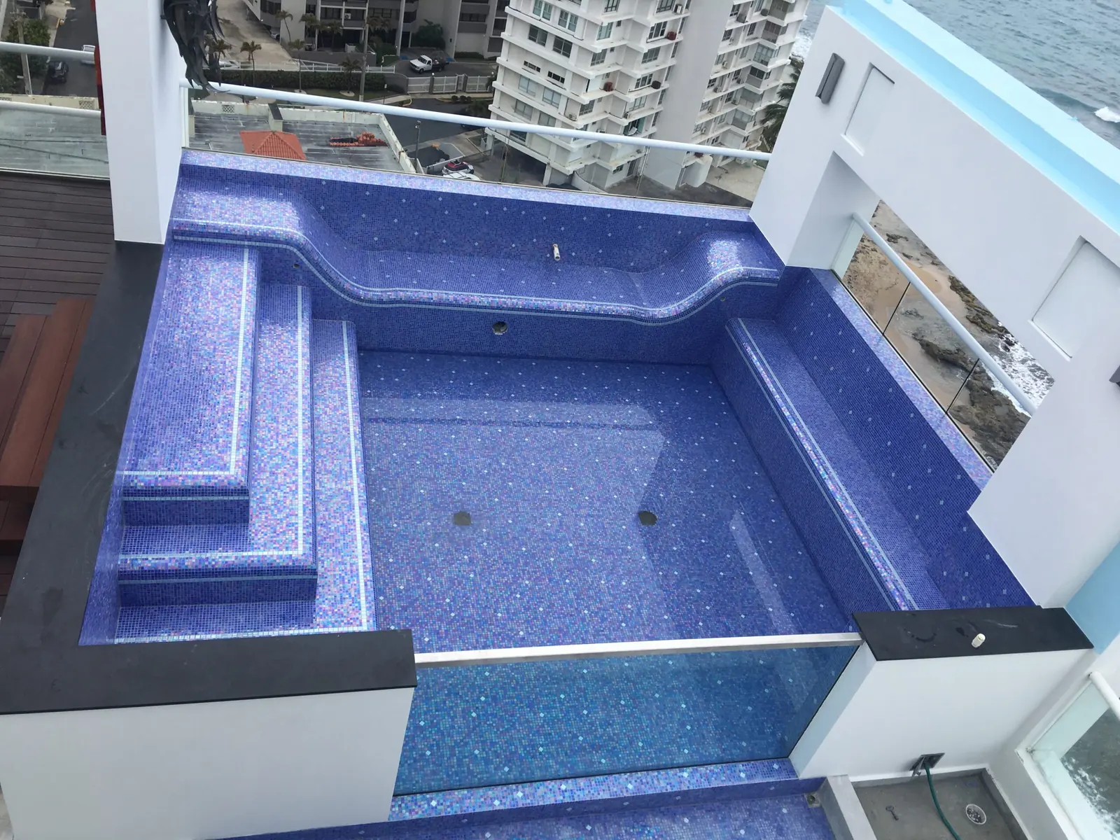 Rooftop pool with blue mosaic tile