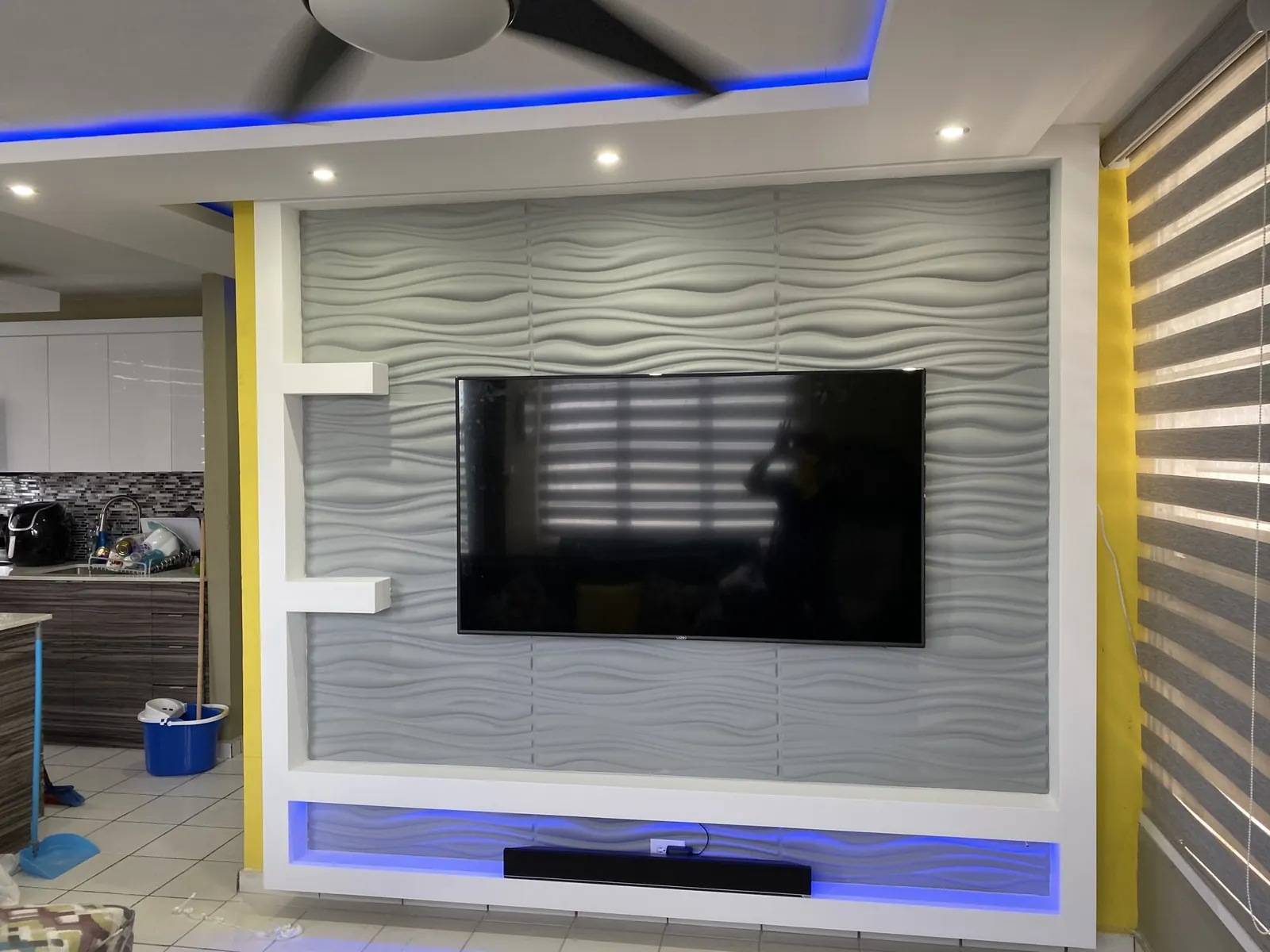 Wave-textured TV wall with LED shelving and a fascia ceiling