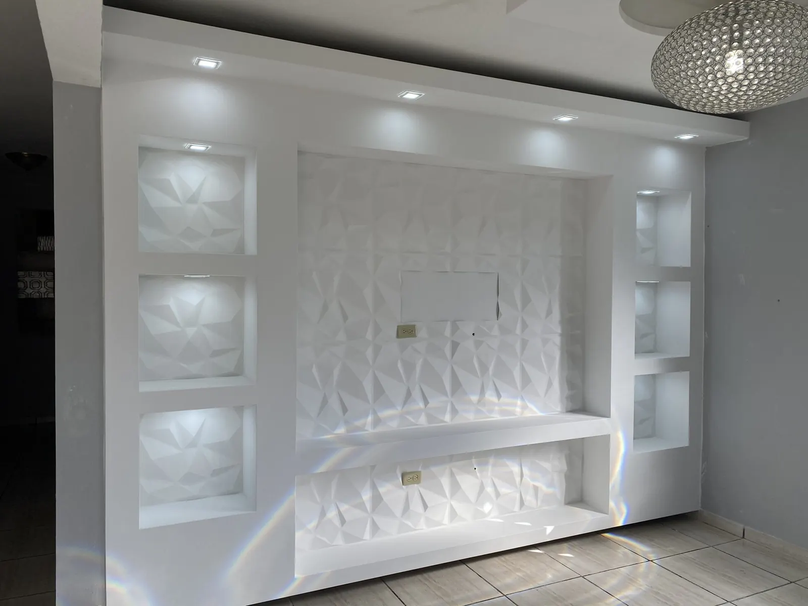 White sculpted feature wall with lit niches
